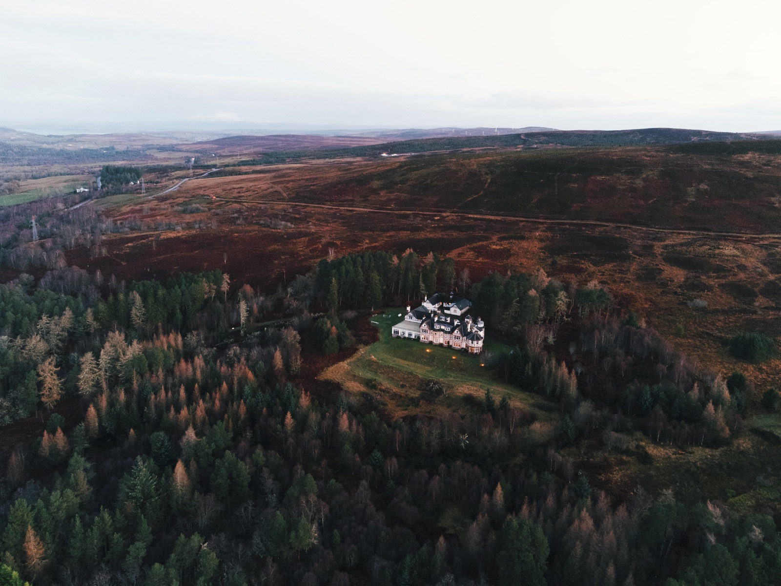 The Coach House at Aultnagar Estate within a broad Highland landscape.
