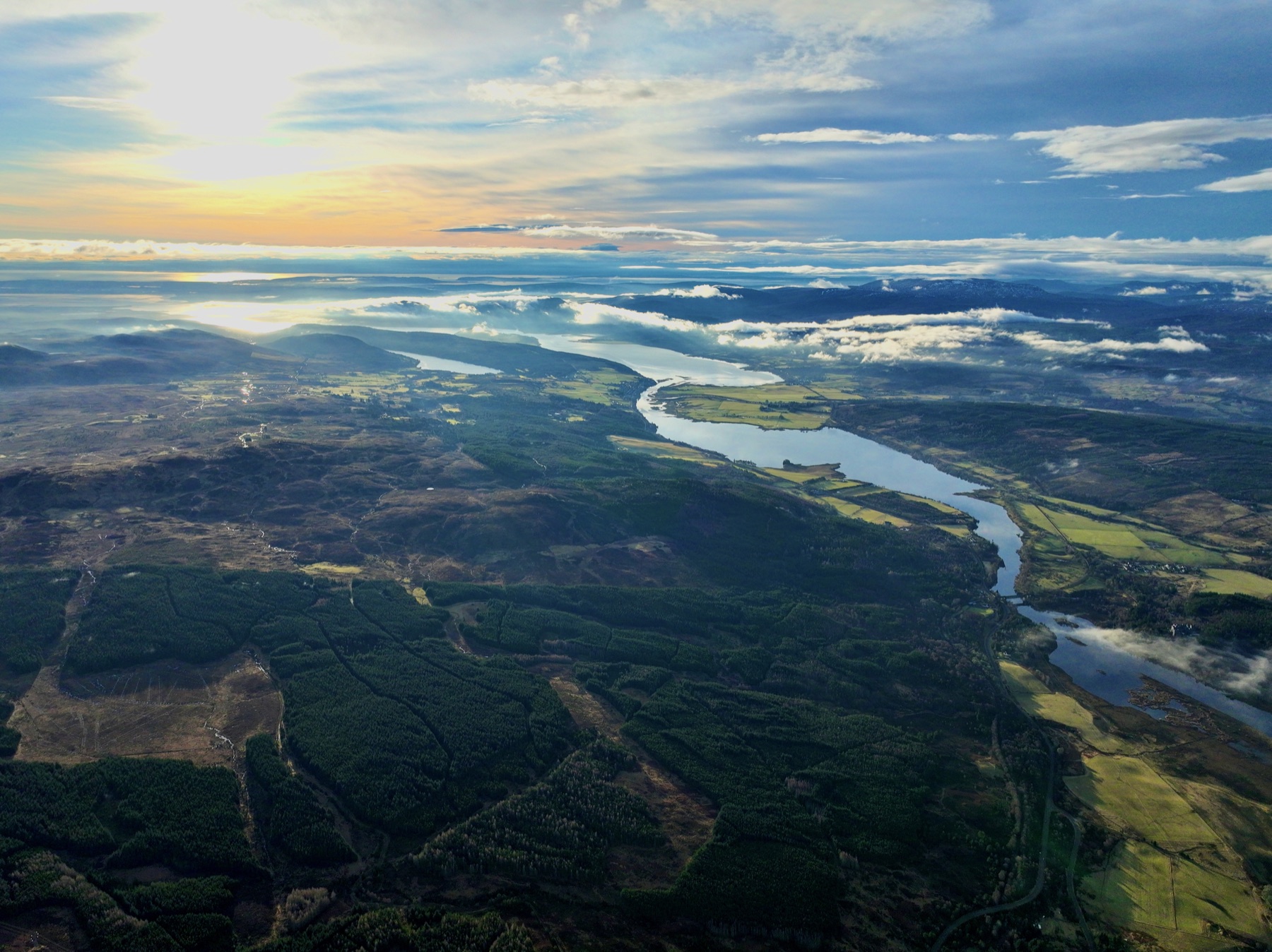 Aerial view of Scottish landscape, water and woodland.